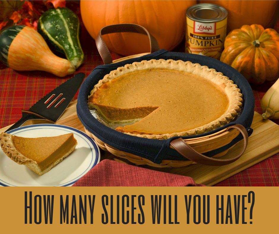 Pumpkin pie sitting on table with a slice cut out